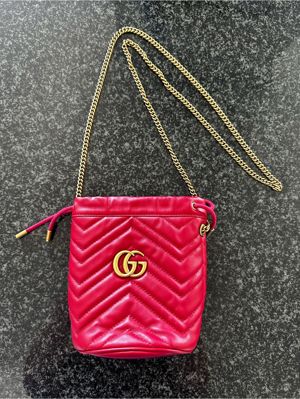 Gucci Mini GG Marmont Bucket Bag in Red Leather with Brass Hardware.